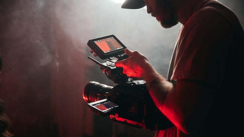 A content creator filming with a camera