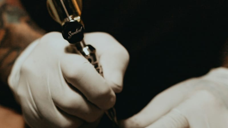 A tattoo artist at work in their studio